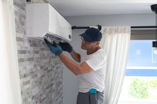 technician service man repairing the air conditioner at home